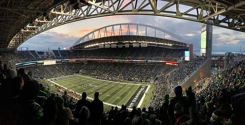 A large stadium filled with spectators watching an exciting football game.