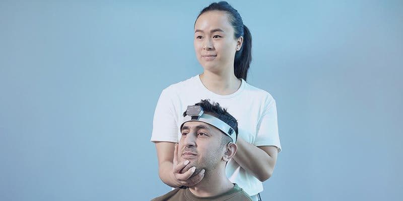 clinician holding head of patient with fvHIT headband on
