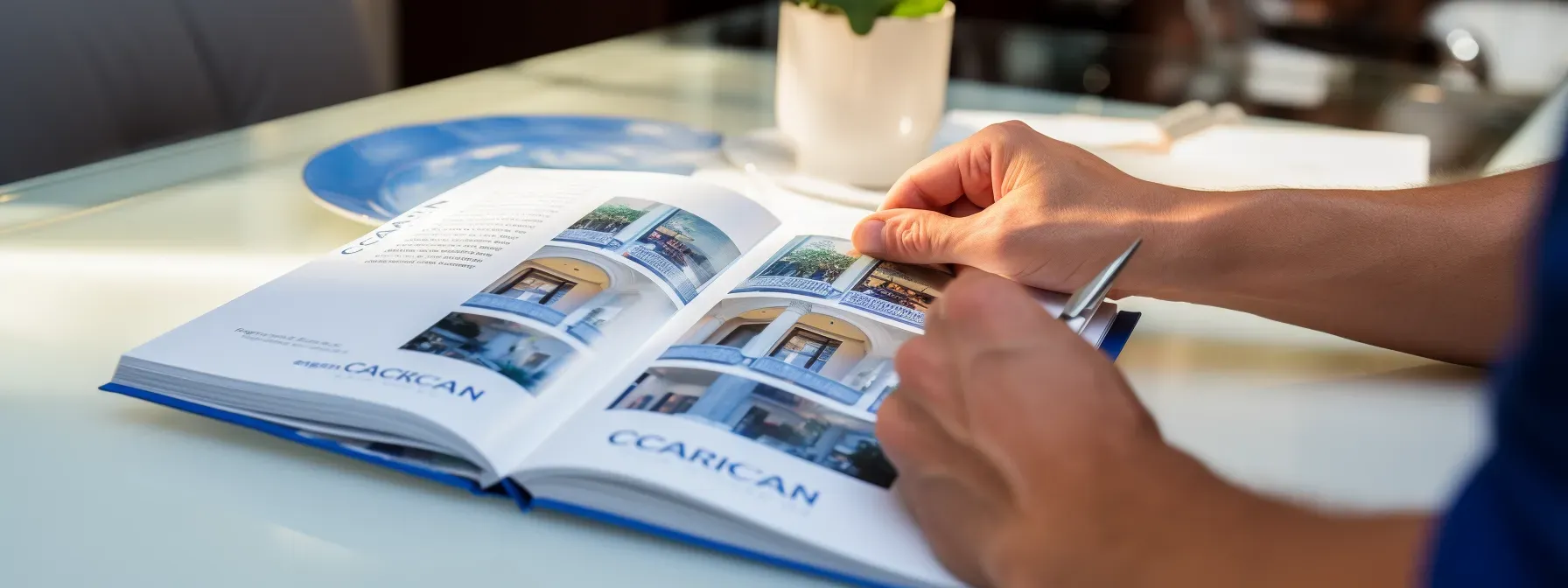 A person holding a caohc certification journey guidebook open with a pen in hand, ready to take notes.