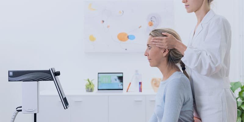 Inventis Synapsis vHit used on woman with clinician holding patients head